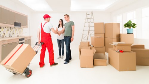 Loading boxes and furniture into a van for a Woodlands move