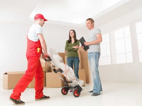 Local movers carrying furniture through a residential street in Woodlands