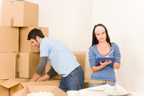 Loading furniture and boxes into a removal van for a Woodlands customer